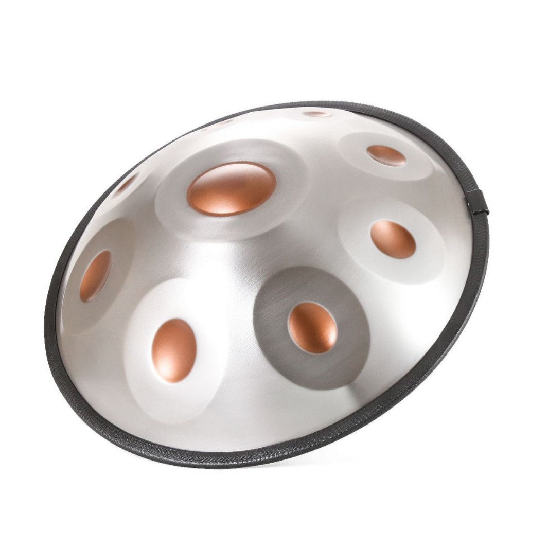 A stainless steel handpan drum with a black rim, featuring multiple circular sound chambers with copper-colored interiors, shown on a plain white background.