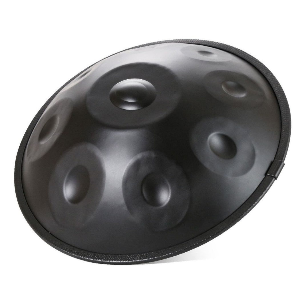 A black steel tongue-and-groove handpan drum, also known as a kenger drum, shown at an angle on a solid white background.