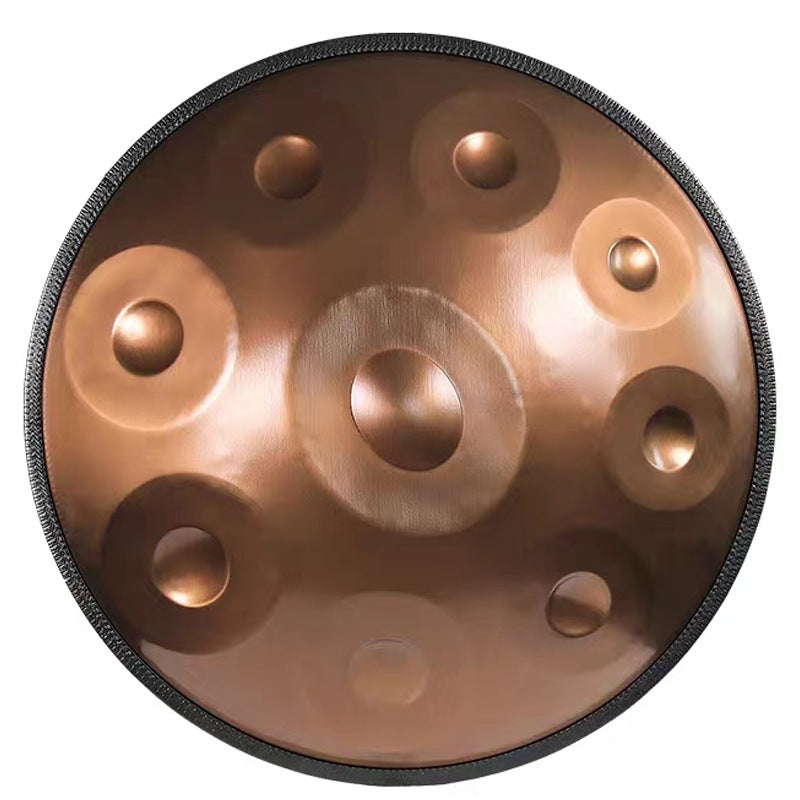 `Gold Ethereal handpan hand dish drum with mallets, resting on a mountain summit above the clouds.