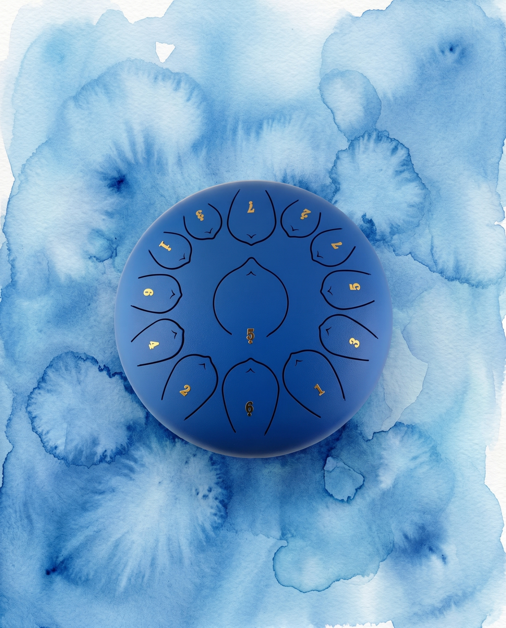 ` Blue Ethereal 12-inch steel tongue drum with numbered notes beneath an ethereal water color sky.