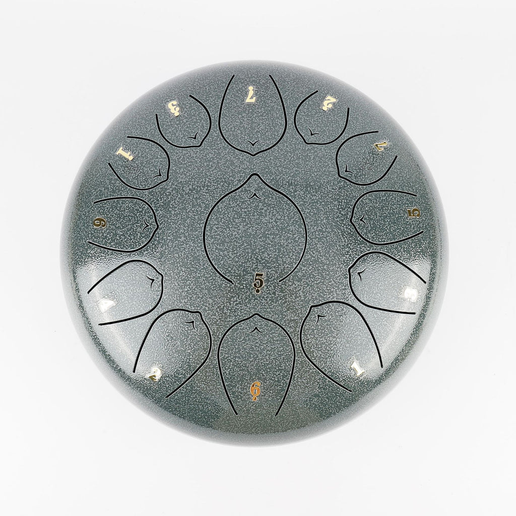 `Jade Celadon Ethereal 12-inch steel tongue drum with numbered notes beneath an ethereal water color sky.