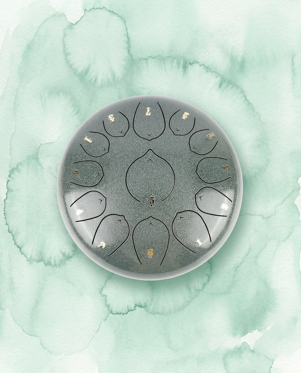 `Jade Celadon Ethereal 12-inch steel tongue drum with numbered notes beneath an ethereal water color sky.