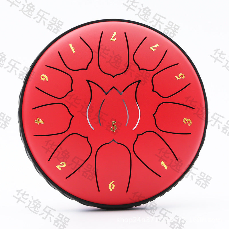 A red metal steel drum with black engraved lines and gold-colored number markings, shown on a white background with diagonal watermark text.